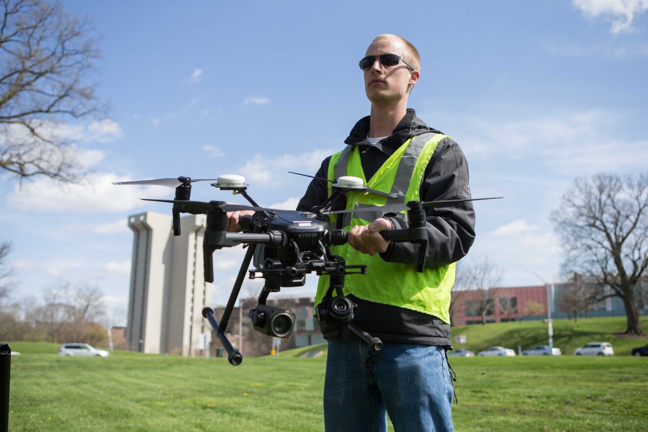 UC graduate Austin Wessels tests a drone on university grounds. UC is helping ODOT study the economics of drone infrastructure development along I-71.